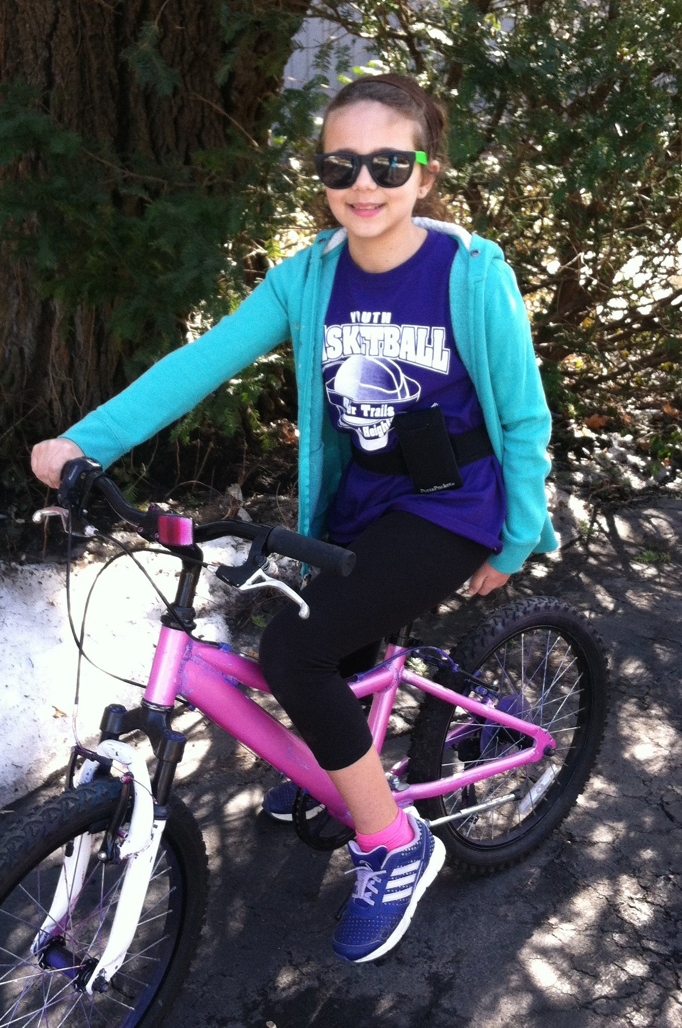 girl on bicycle with PortaPocket around waist