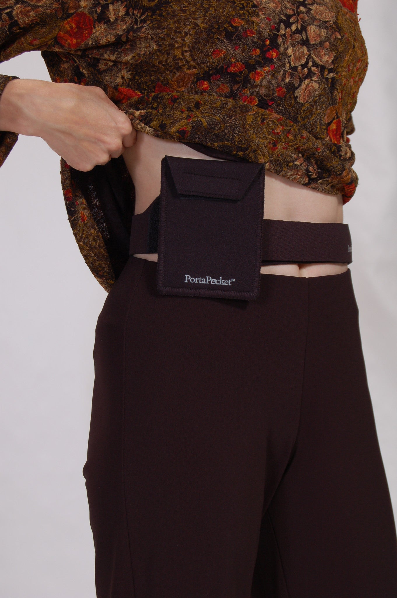 lifting a top to show hidden passport holder at waist / hip. Simple, convenient & versatile waist pocket belt 
