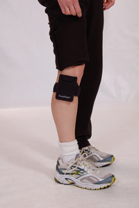 Workout pants lifted to show where PortaPocket pocket is hiding on leg
